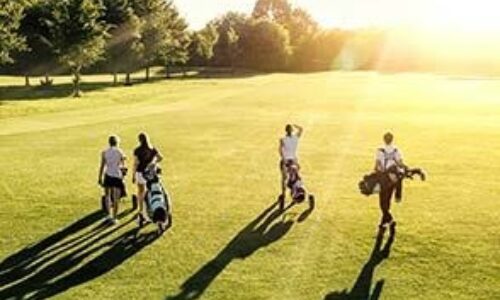 A group of four people golfing