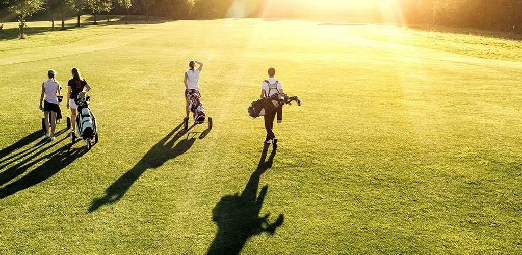 A group of four people golfing