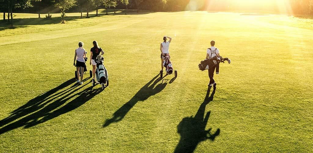 A group of four people golfing