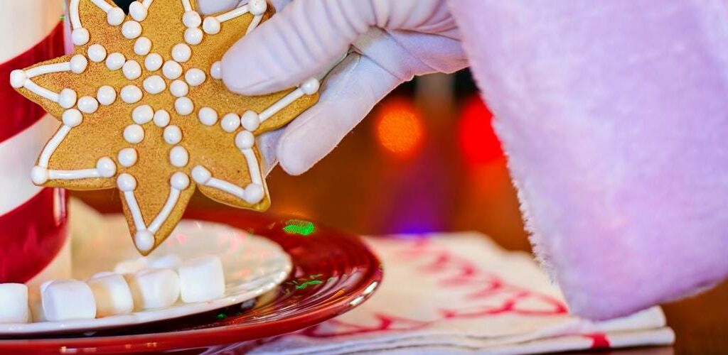 Cookies being put on a plate with mini marshmallows